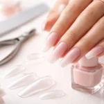 Coffin Shaped Nails showing a tapered shape with a flat tip in medium length with a glossy nude finish
