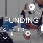 Image of a businessman reviewing documents, overlaid with financial icons and graphs. The word 'FUNDING' is prominently displayed, suggesting a focus on financial analysis or investment.