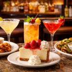 Cheesecake Factory Happy Hour menu favorites with drinks and small plates on a bar table